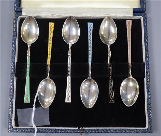 A cased set of 1950s silver and enamel coffee spoons.
